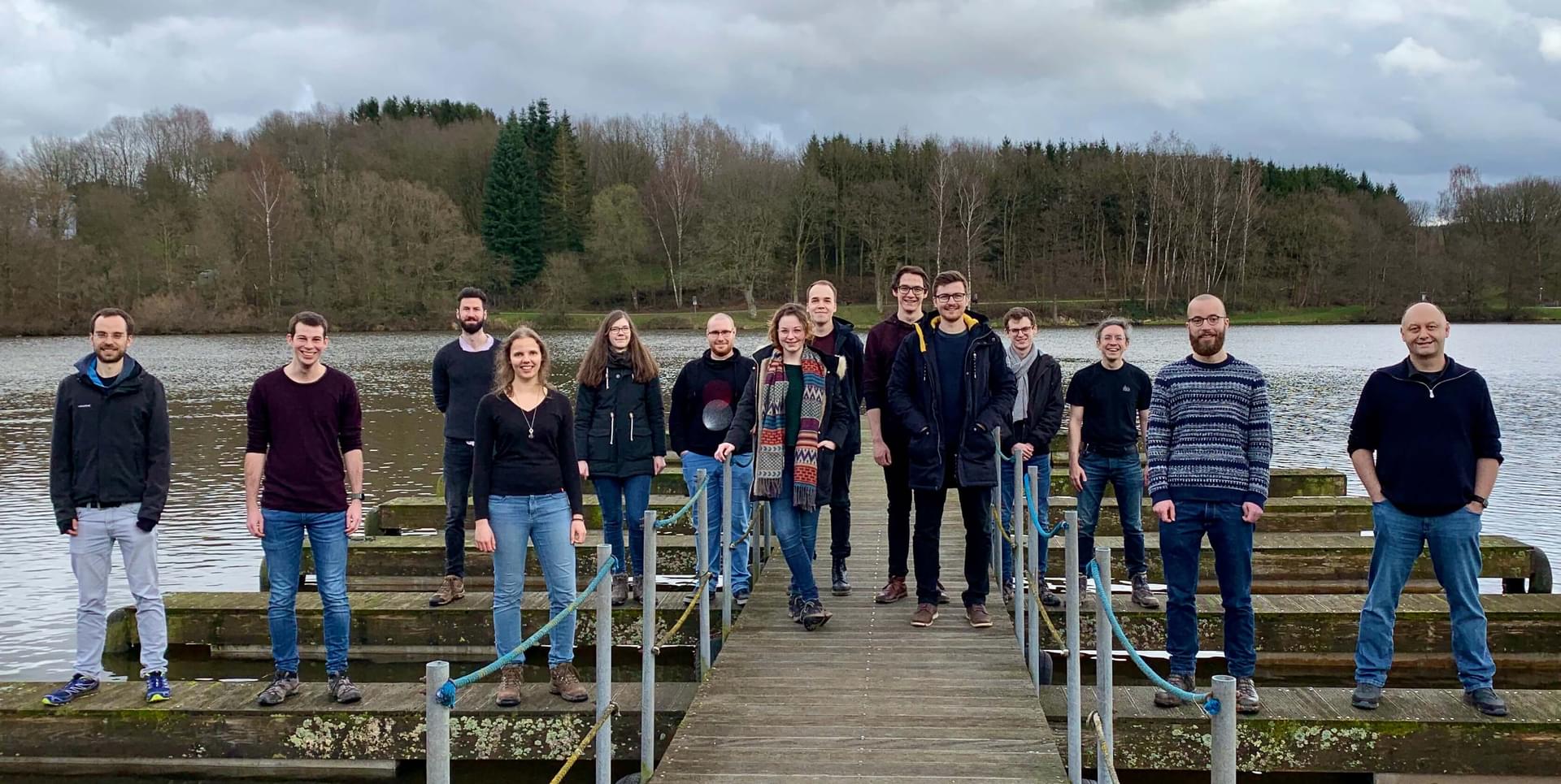 group photo of the Reactive System Group in front of a lake